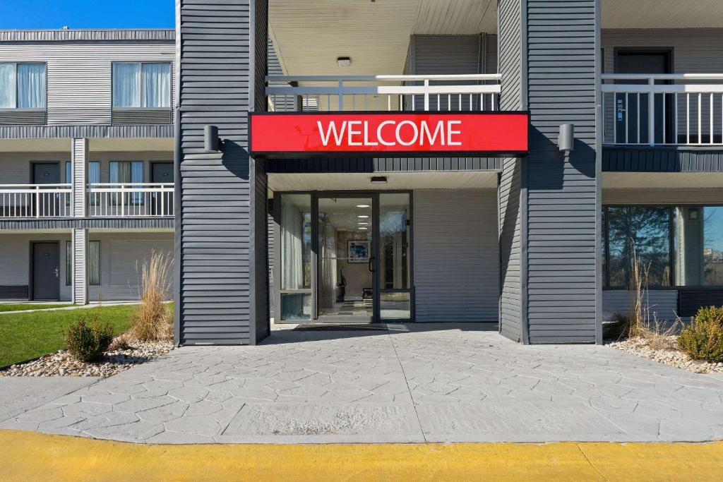 a welcome sign in front of a building at Econo Lodge in Rockford