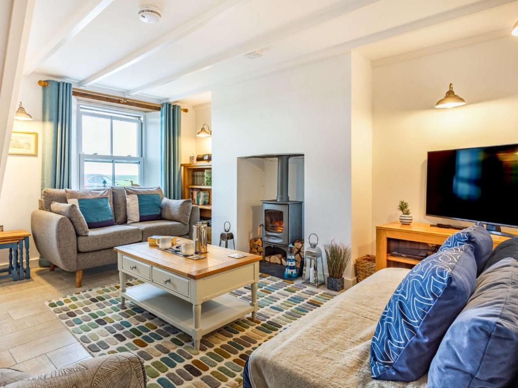 a living room with a couch and a tv at 2 Bed in Fowey 86873 in Saint Veep