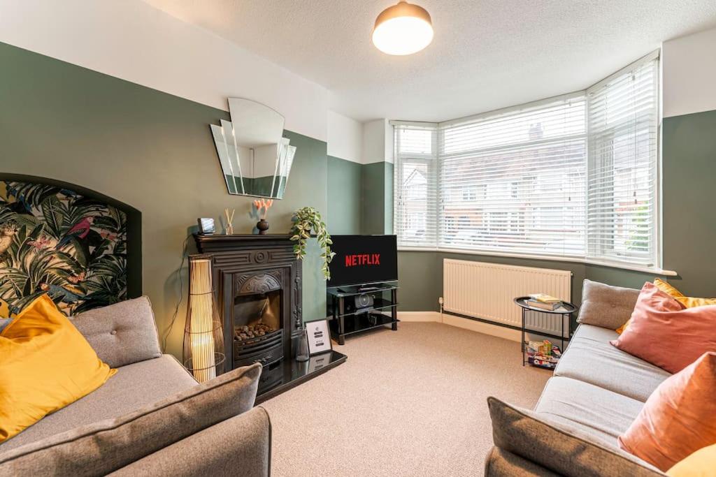 a living room with two couches and a fireplace at Stunning Serviced Accommodation Near City Centre in Allesley