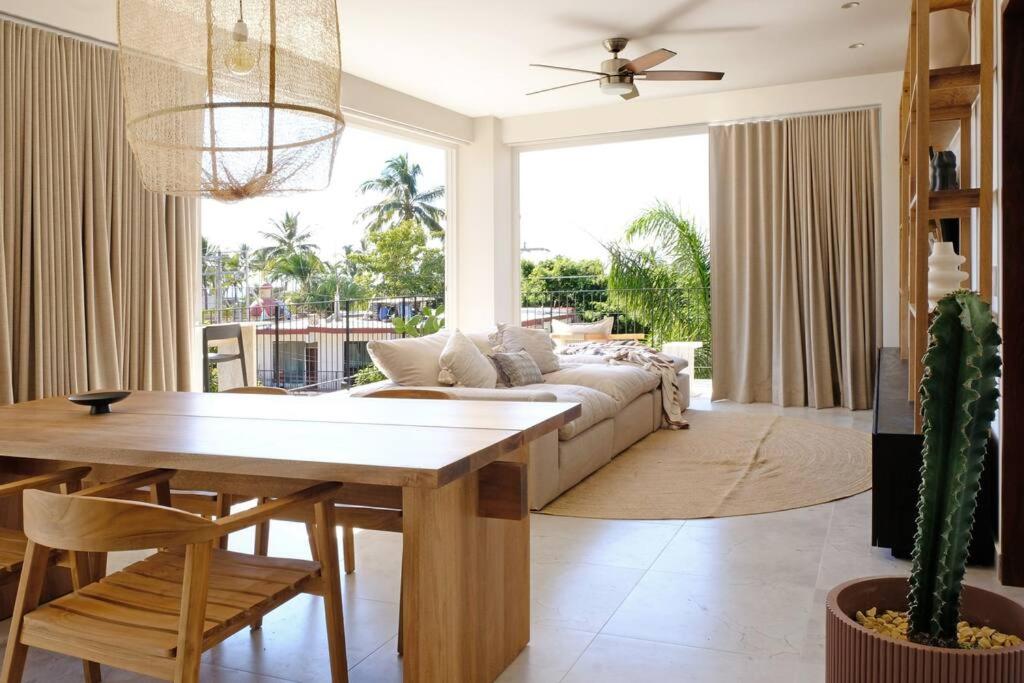 a living room with a couch and a table at Pacifica by Pardela in Bucerías