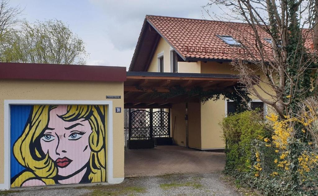 a painting of a woman on the side of a house at Ferienwohnung in Grafing Bei München mit Großem Garten in Grafing