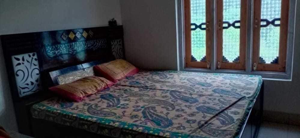 a bedroom with a bed with a design on it at OYO Home Navya Homestay in Chāndal