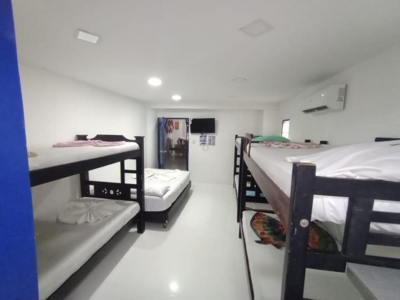 a group of bunk beds in a room at HOTEL VISTA AL MAR habitacion para 6 personas in Rodadero