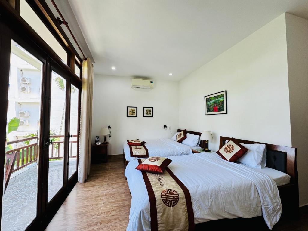 Postel nebo postele na pokoji v ubytování Thuy House Hoi An