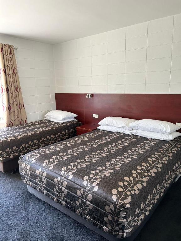 Postel nebo postele na pokoji v ubytování Tudor Motor Lodge