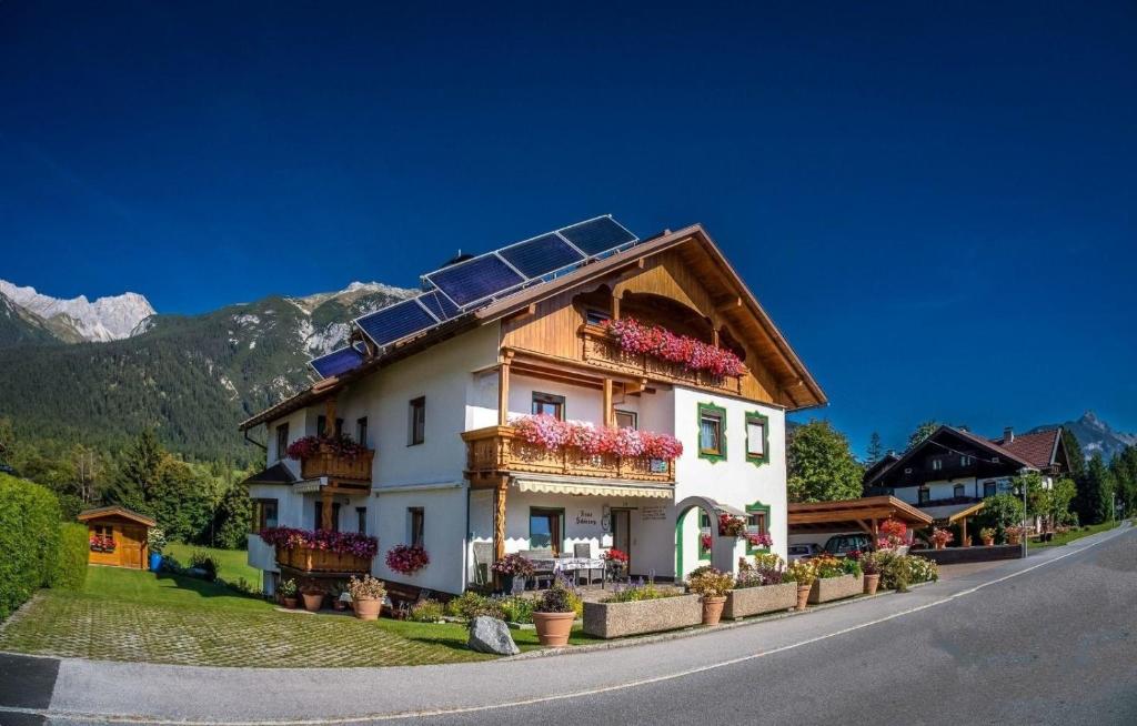une maison avec des panneaux solaires sur le toit dans l'établissement Ganze Wohnung in Leutasch mit Privatem Balkon - a80944, à Leutasch