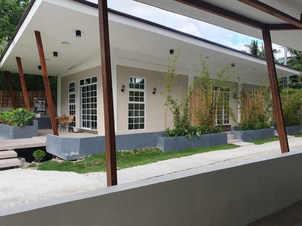 a view of a house through a glass window at Fins Pacific Coray Bay by Hiverooms in Samboan