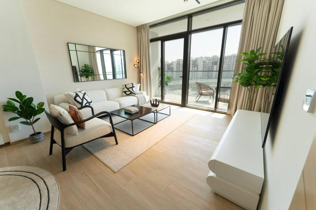 a living room with a couch and a table at The Palace I Luxury 2BD I Dubai Creek Harbour in Dubai