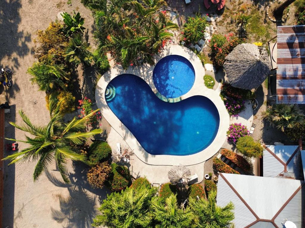 an overhead view of a swimming pool in a resort at Bioluminiscencia Hostel Tours - South in Paquera