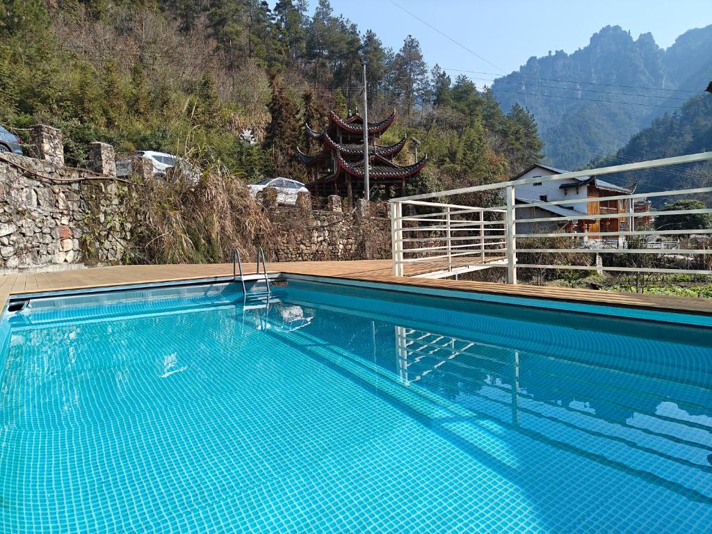 a swimming pool with a view of a mountain at Whispering Mountains Boutique Hotel in Zhangjiajie