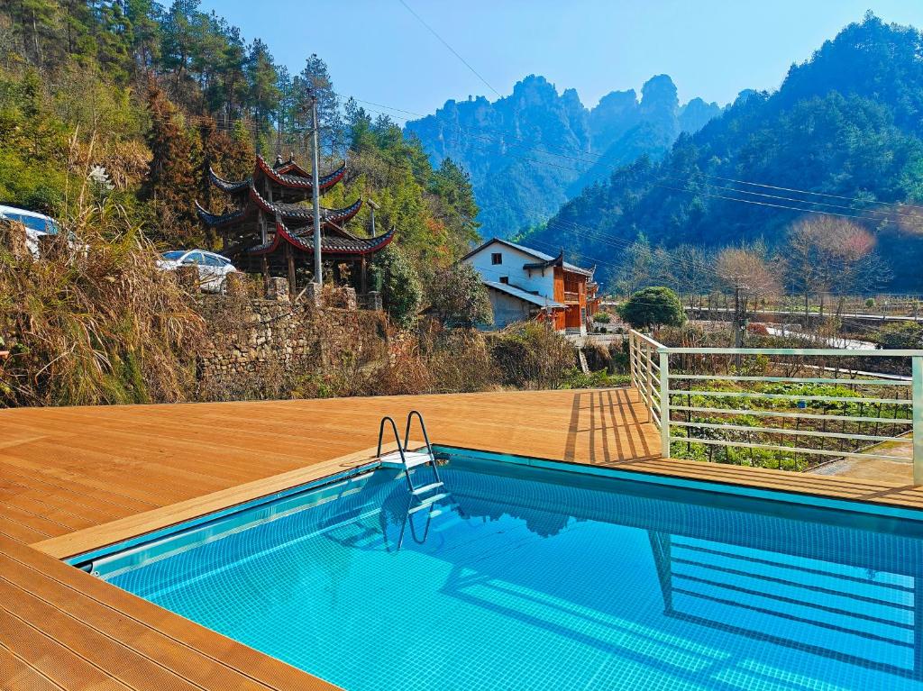 a swimming pool with a view of a mountain at Whispering Mountains Boutique Hotel in Zhangjiajie