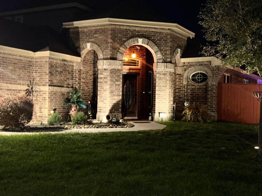 a brick house with a front door at night at Humble Home in San Antonio