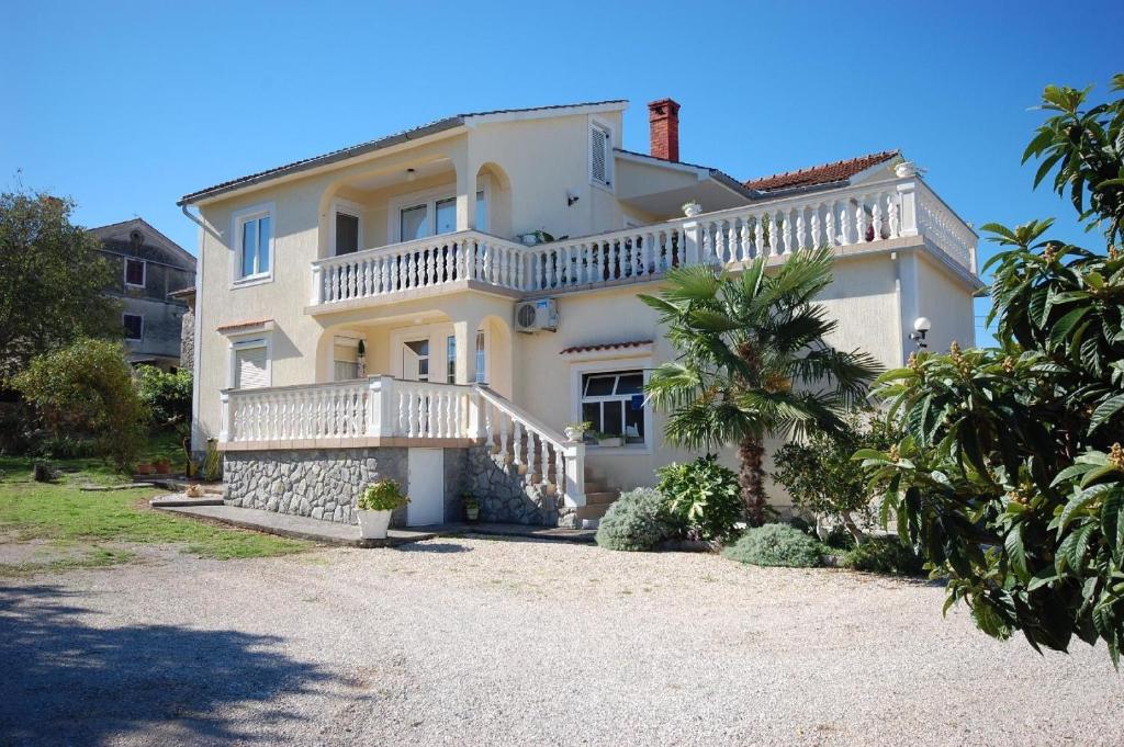 a large white house with a large balcony on it at Ferienwohnung für 4 Personen ca 65 qm in Bogovići, Kvarner Bucht Krk in Malinska