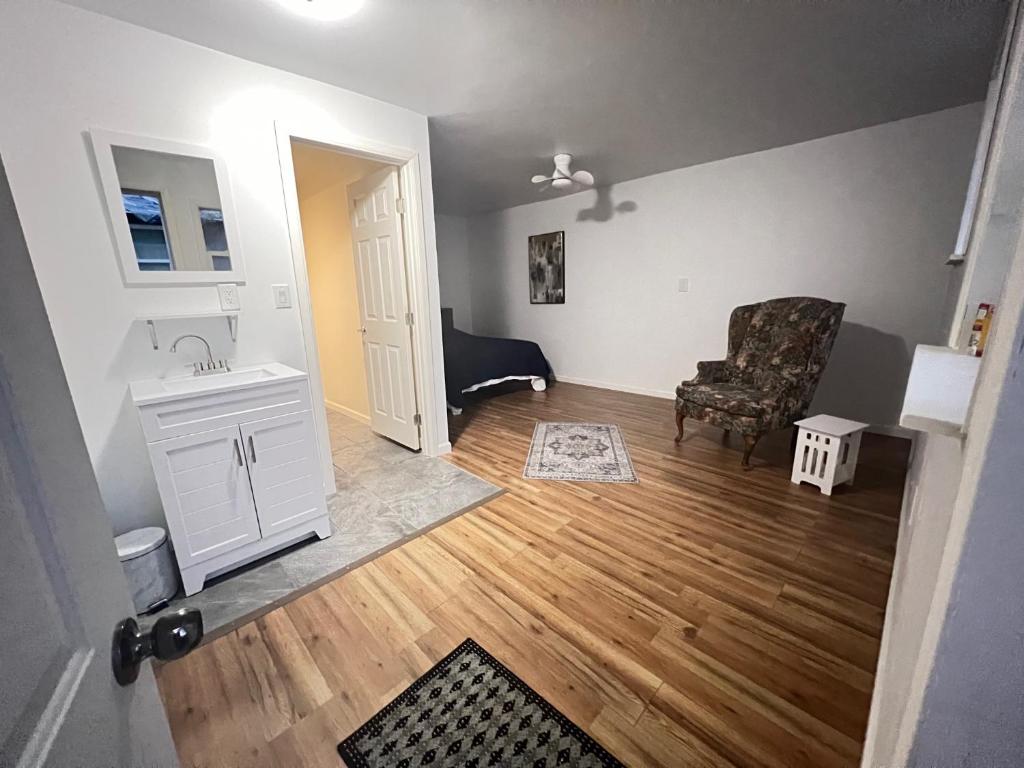 an empty living room with a chair and a sink at LittleBetty's LandingPad in Torrance