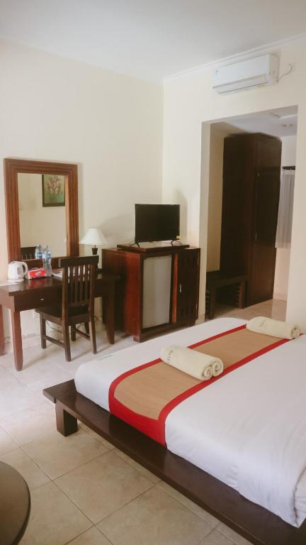 Postel nebo postele na pokoji v ubytování New Puri Asih Hotel