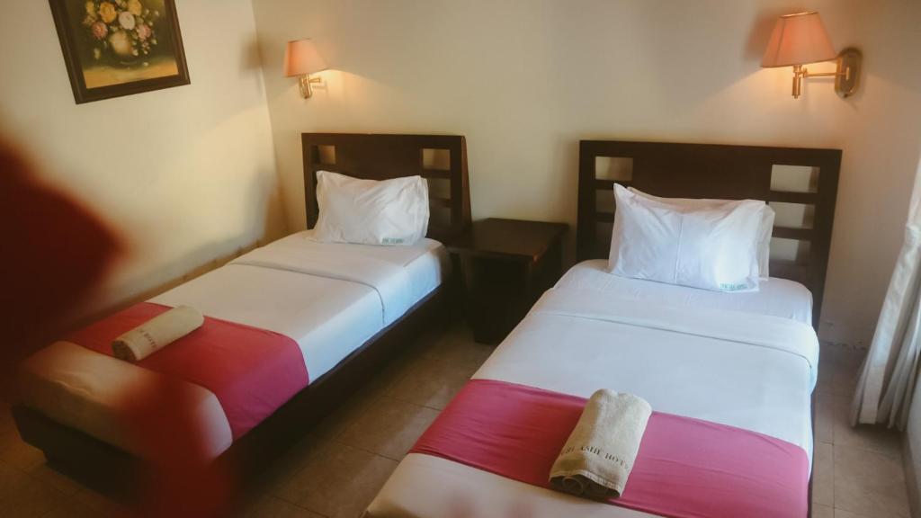 Postel nebo postele na pokoji v ubytování New Puri Asih Hotel