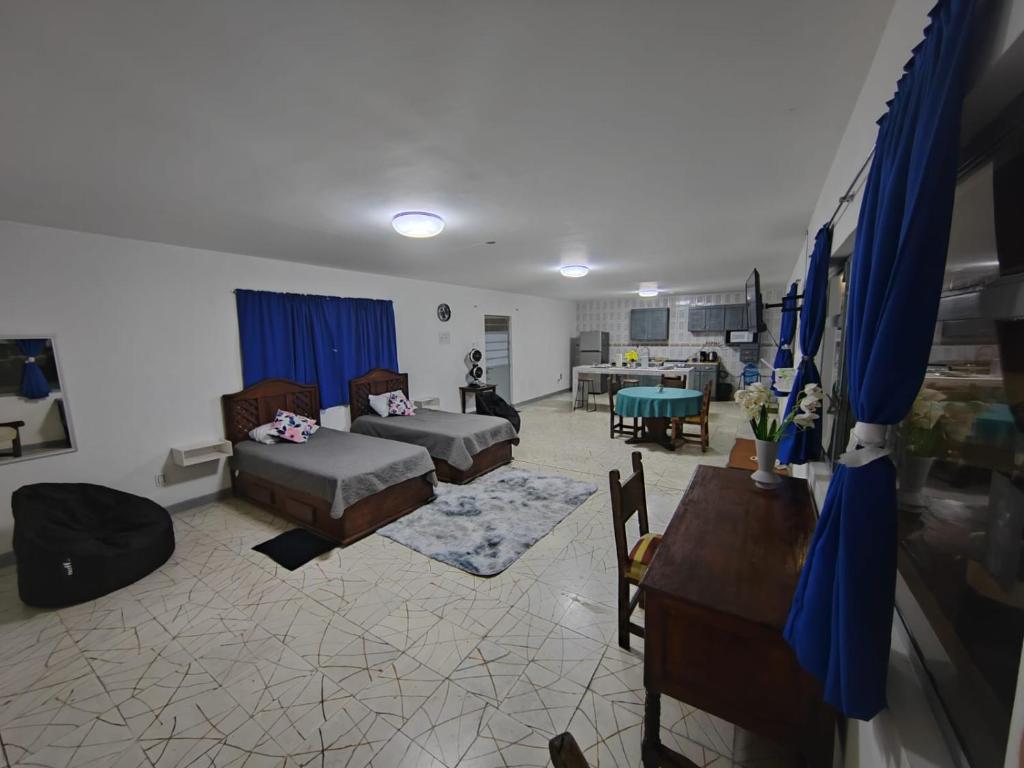 a living room with two beds and a table at Departamento amplio con hermosa vista in Puebla