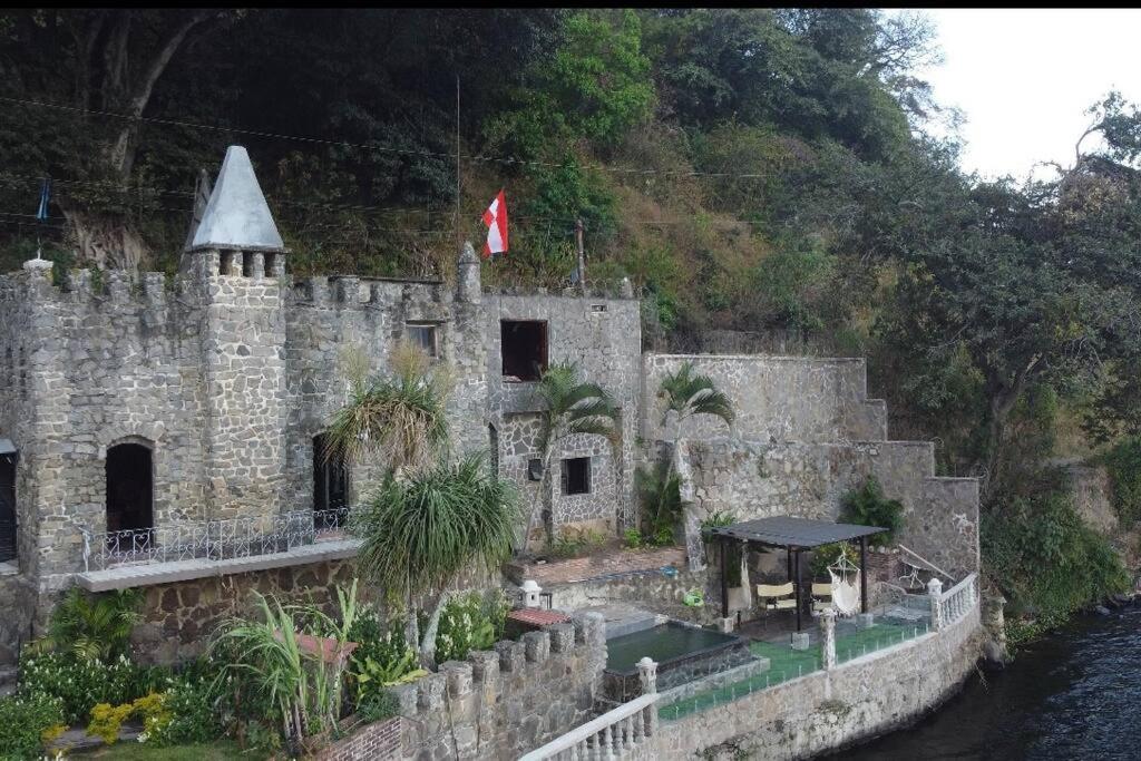 ein altes Schloss am Ufer eines Flusses in der Unterkunft Casttle Atocha in Amatitlán