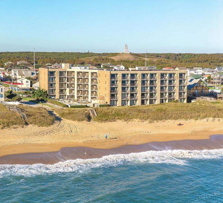 an aerial view of a hotel and the beach at Ocean Reef Suites in Kill Devil Hills