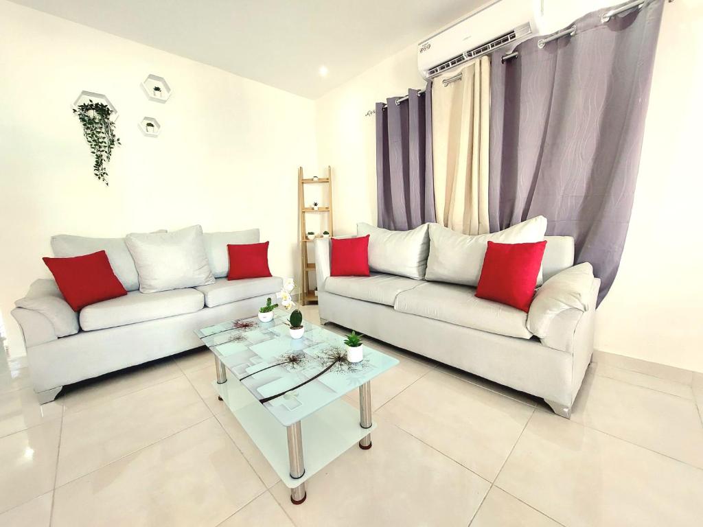 - un salon avec deux canapés et une table basse dans l'établissement ¡Tu refugio tropical en La Romana!, à La Romana