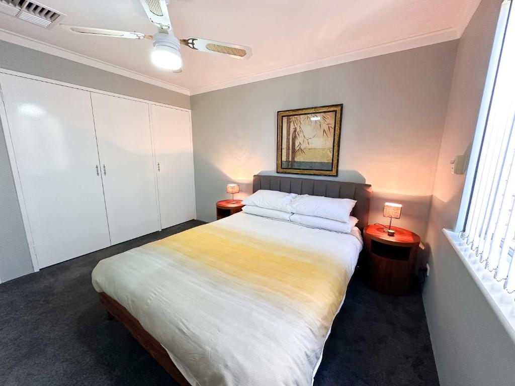 a bedroom with a large bed and two night stands at Rockingham Palace in Rockingham