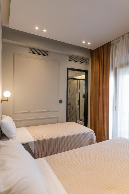 Posteľ alebo postele v izbe v ubytovaní Aggelos Hotel