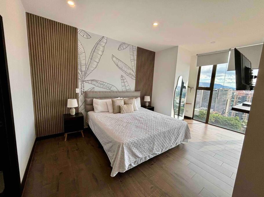 a bedroom with a bed and a large window at Luxury 2 Bedroom apartment with pool in Guatemala