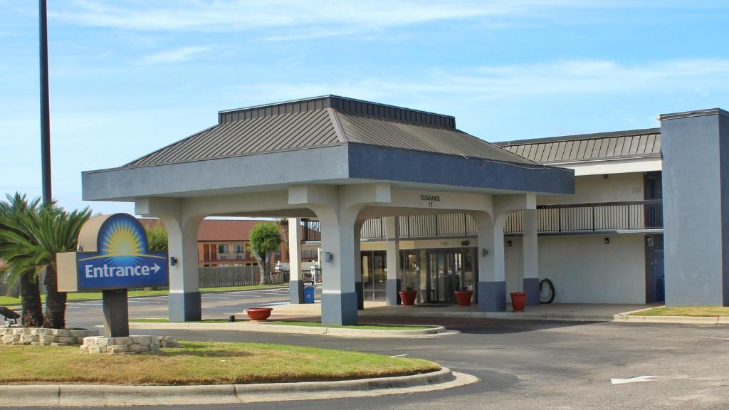 a gas station with a sign in front of it at Days Inn by Wyndham Marianna in Marianna