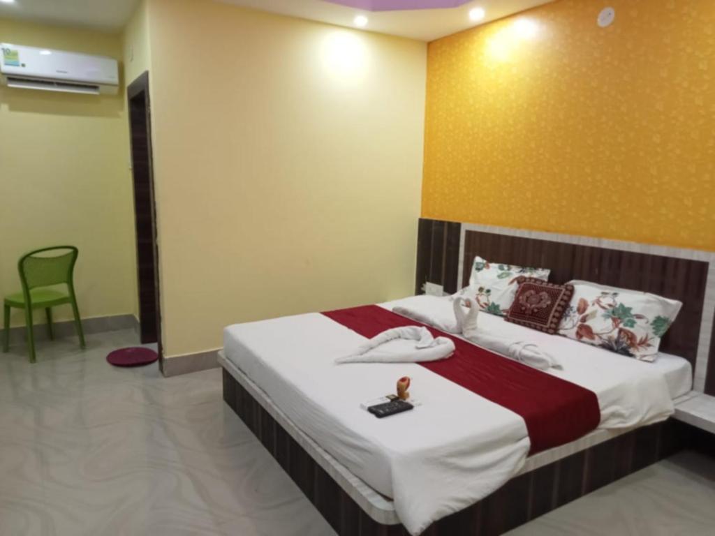 a bedroom with a large bed with at Hotel Sashi Puri Near Sea Beach & Temple - Best Choice of Travellers in Puri