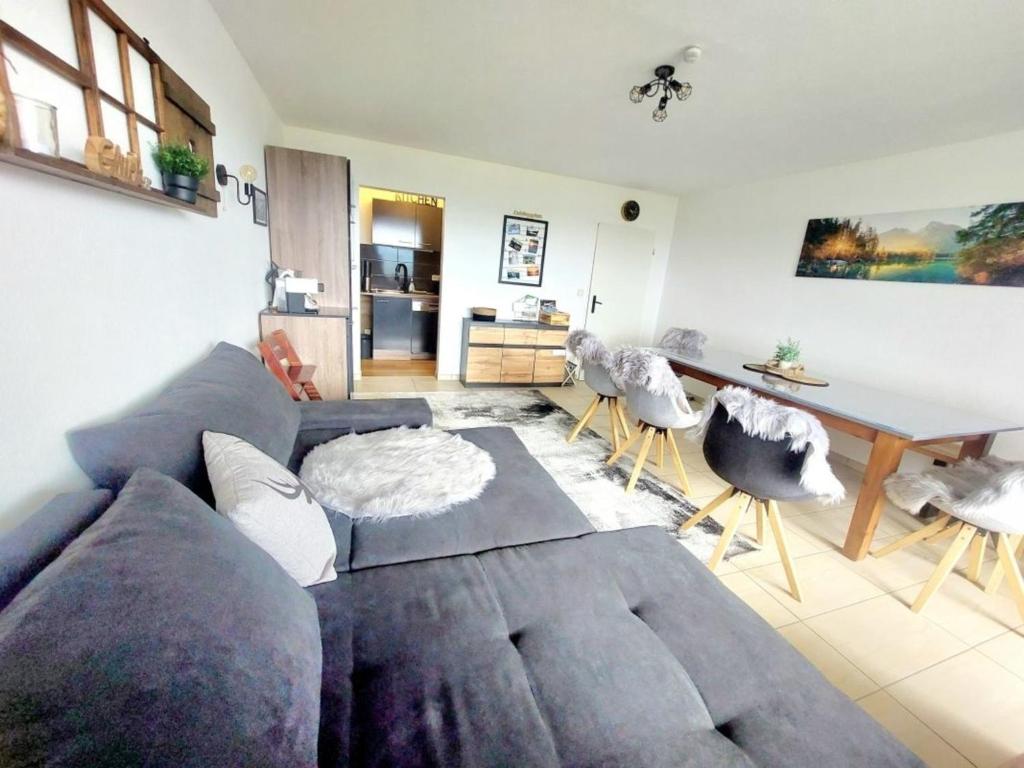 a living room with a couch and a table at Alp-Juwel mit Pool und Sauna für Familien und Hunde ideal in Missen-Wilhams