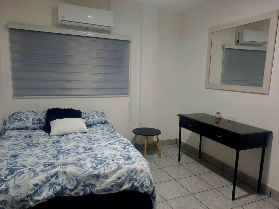 - une chambre avec un lit, un bureau et une fenêtre dans l'établissement hogar, dulce hogar 1, à Torreón