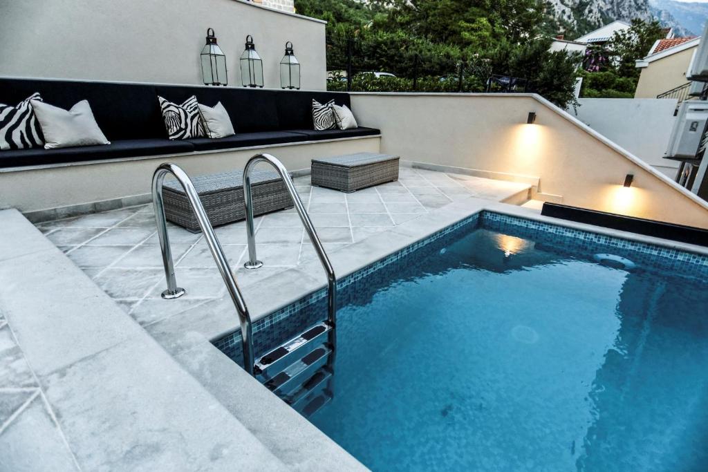 uma piscina com um banco ao lado em Boutique Hotel Casa del Mare-Pietra em Kotor