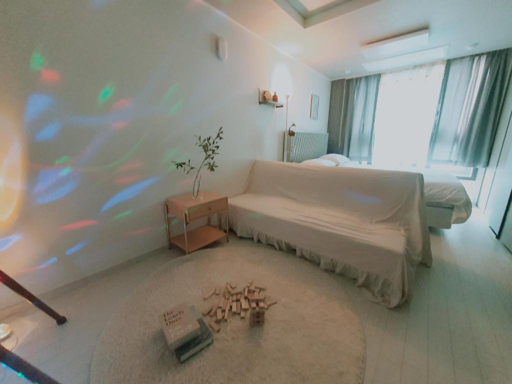 a bedroom with a bed and a large window at Dongseongro Cozy House in Daegu
