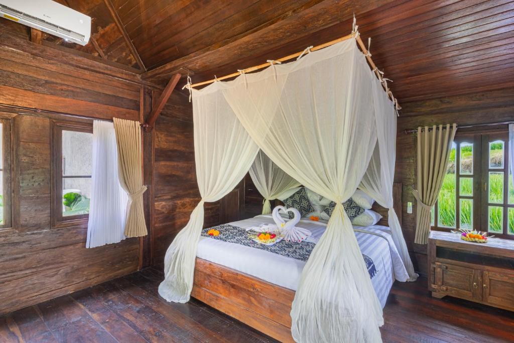 Postel nebo postele na pokoji v ubytování Abian Ubud View