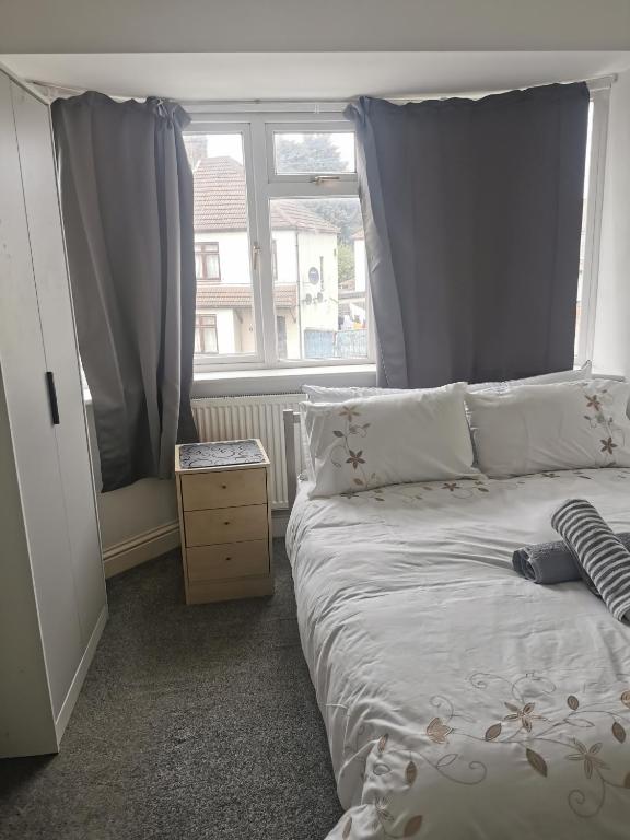 a bedroom with a bed and a large window at Deluxe Double Room Cosy and Comfortable FFDBL7 in Barking