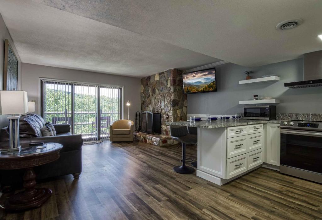 a large kitchen with a living room with a couch at 1023 English Mtn Condo By Beyond Expectations in Sevierville