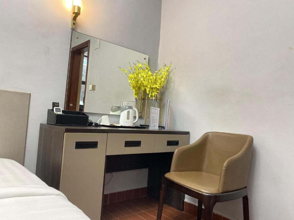 1 dormitorio con escritorio, espejo y silla en THE DREAMS HOTEL, en Douala