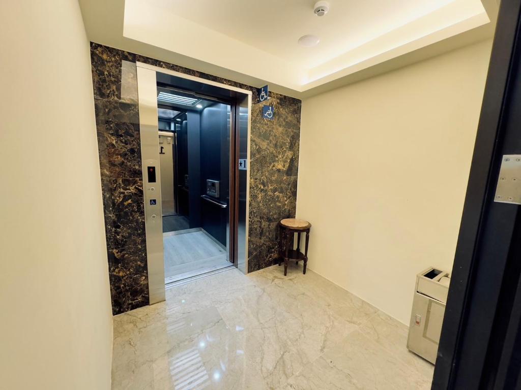 a bathroom with a walk in shower and a tub at Dafong Hotel in Zhongzheng