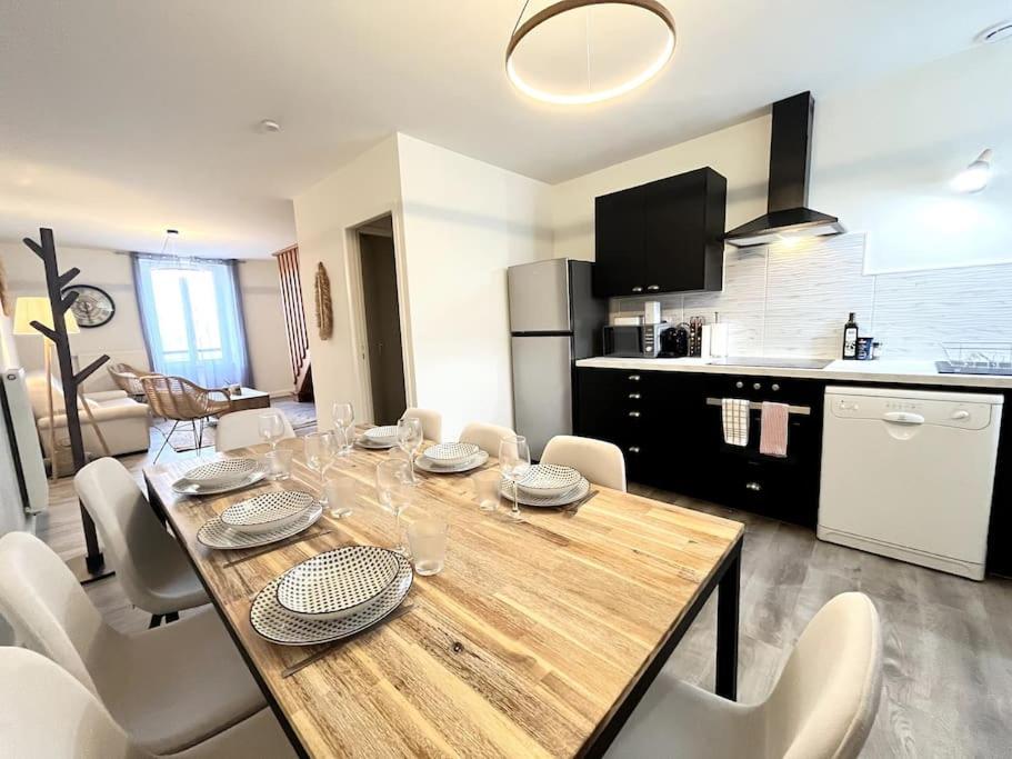 a dining room table with chairs and a kitchen at Le Quartz Jaune terrasse / Bourg-de-Péage in Bourg-de-Péage