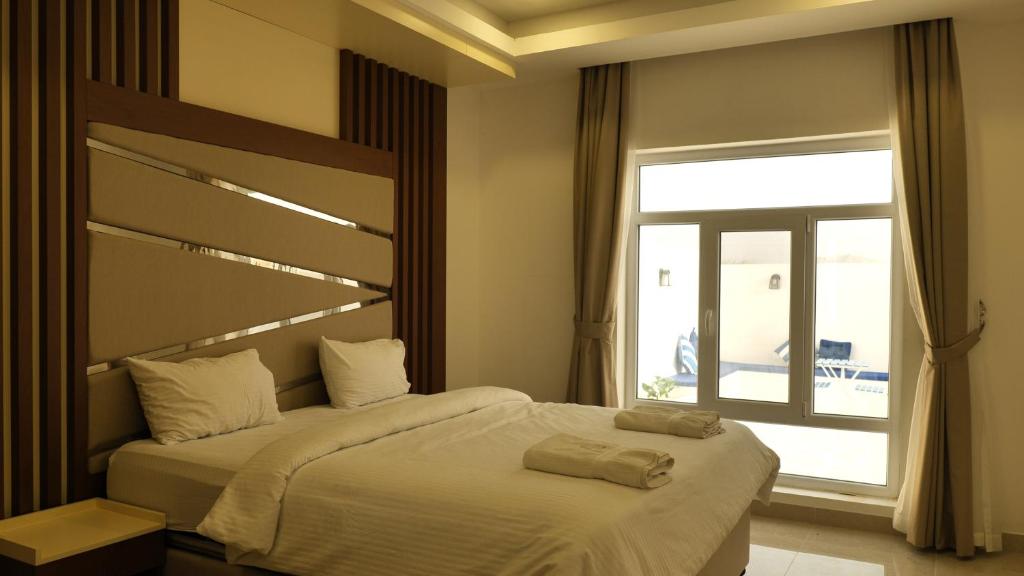Postel nebo postele na pokoji v ubytování Palms Residence Inn دار النخيل
