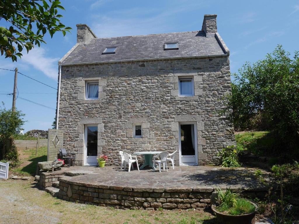 a stone house with a table in front of it at Granite stone house with fireplace, Plouguerneau in Plouguerneau