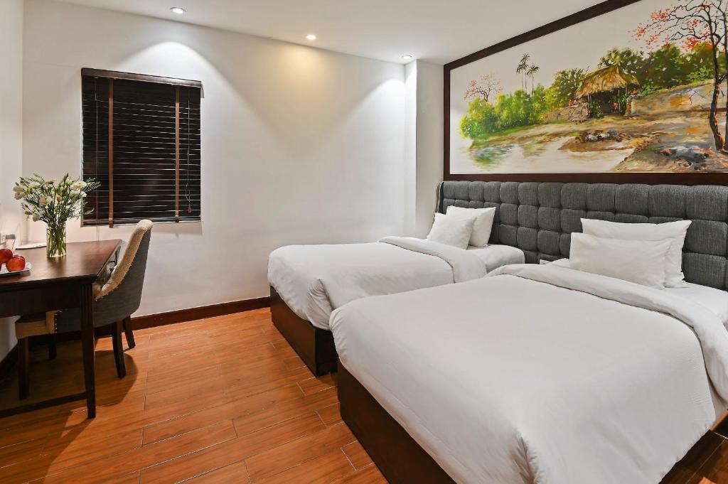 Postel nebo postele na pokoji v ubytování 22Land Residence Hotel & Spa Hanoi