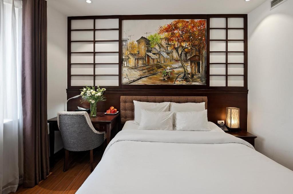 Postel nebo postele na pokoji v ubytování 22Land Residence Hotel & Spa Hanoi