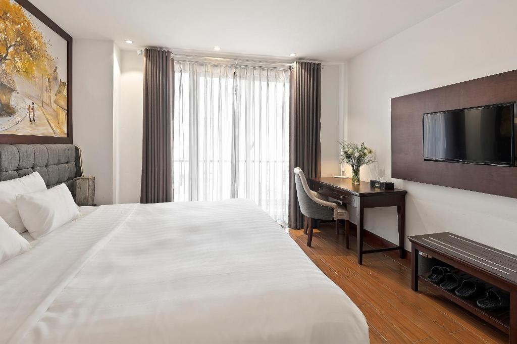 Postel nebo postele na pokoji v ubytování 22Land Residence Hotel & Spa Hanoi