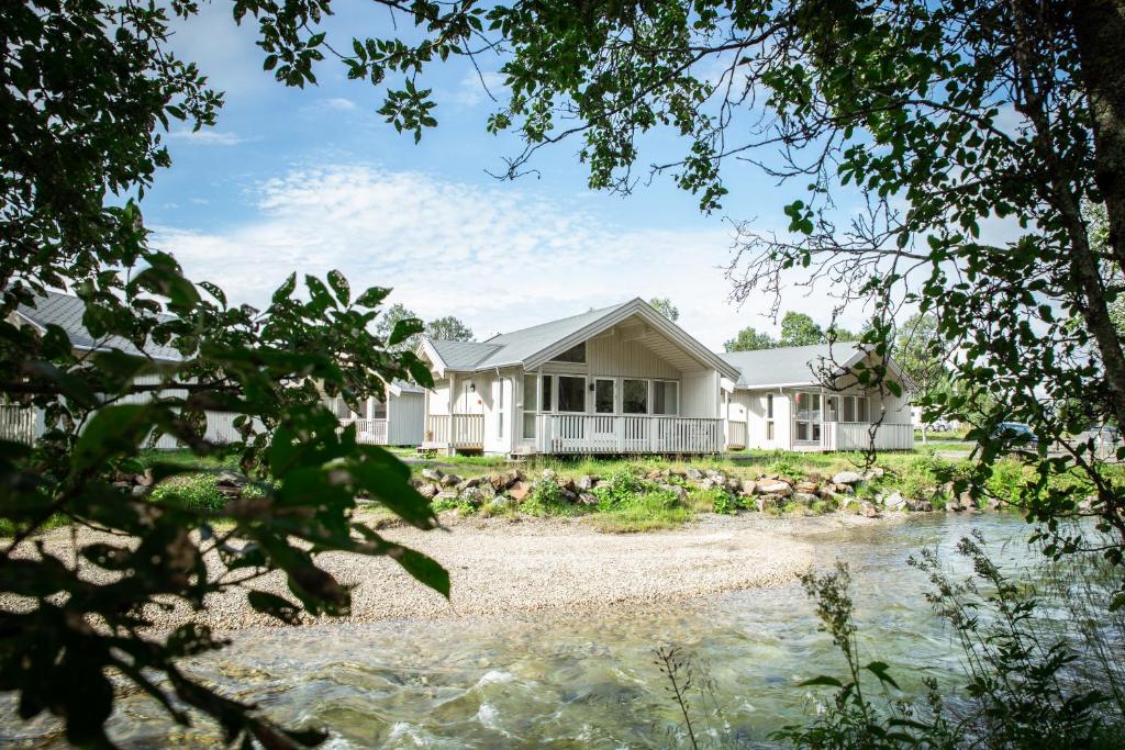 a house on the shore of a river at Tromsø Lodge & Camping in Tromsø