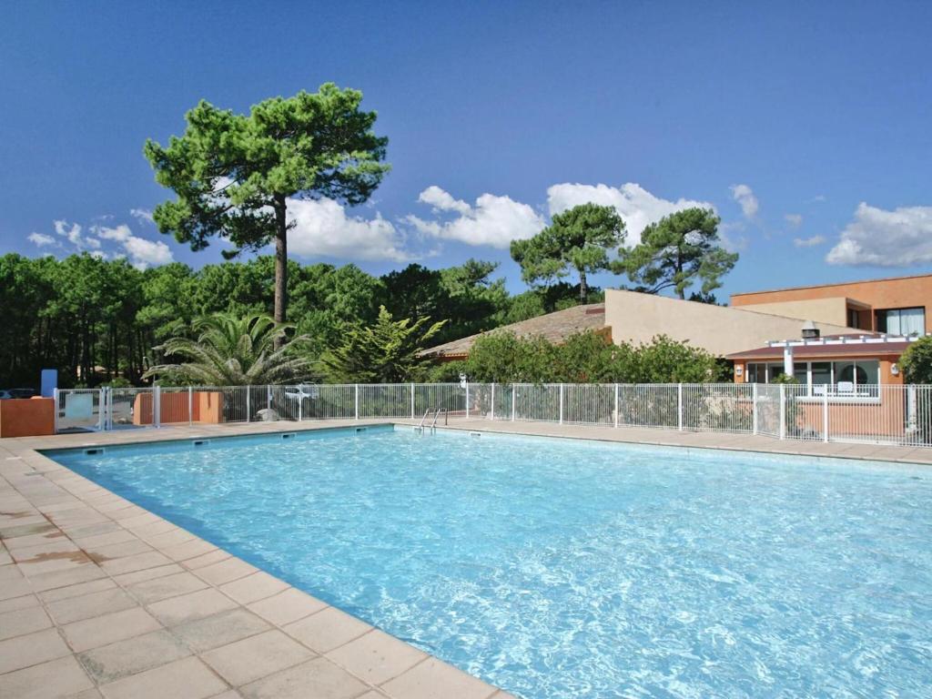 a large swimming pool with blue water at Lovely apartment in Borgo with shared pool in Borgo
