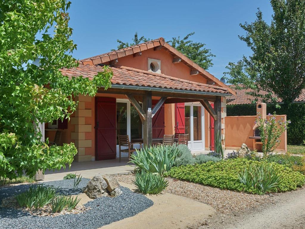 a small house with a porch in a garden at Luxe villa in Les Forges with BBQ Garden in Les Forges