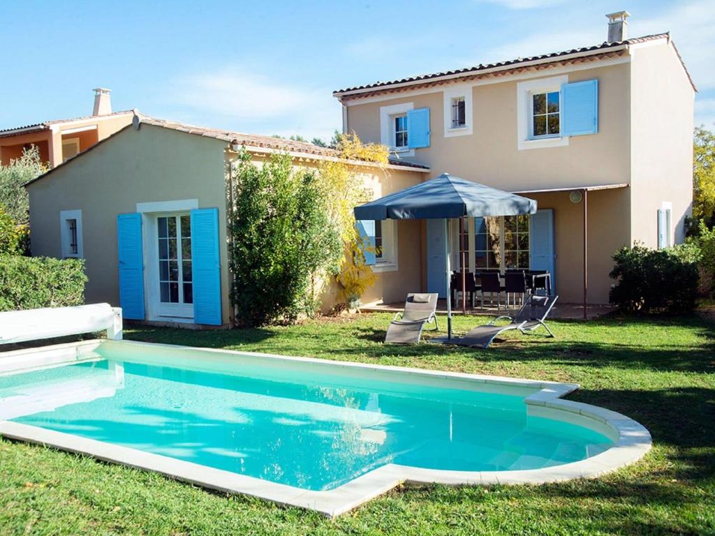 a swimming pool in front of a house at Luxury Provencal villa with AC, in charming Luberon region in Saint-Saturnin-dʼApt