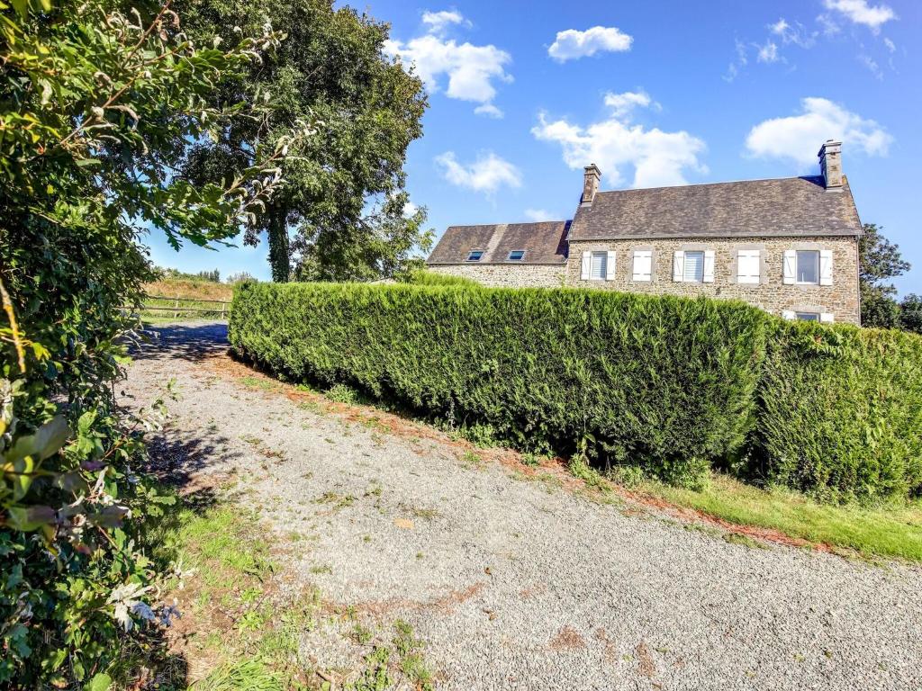 an estate with a hedge in front of a house at Welcoming Holiday Home in Brainville with Fenced Garden in Brainville