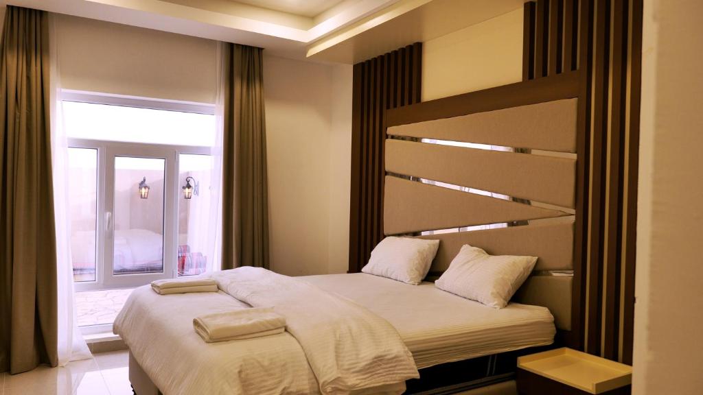 Postel nebo postele na pokoji v ubytování Palms Residence Inn دار النخيل